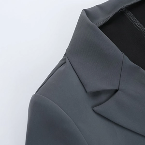 Detail of notch lapel and dark grey woven fabric on professional long sleeve blazer