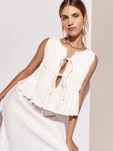 Elegant white sleeveless linen vest with pleated design and tie-front cutout details