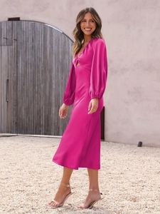 Detail of magenta satin midi dress with lantern sleeves and front cutout detail