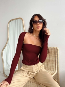 Detail of burgundy square neck long sleeve slim top paired with khaki utility pants