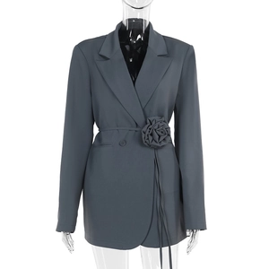 Detailed view of charcoal grey blazer with waist 3D flower accent and thin belt