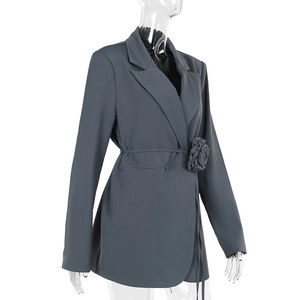 Detail of dark grey blazer featuring waist tie design and 3D floral rose decoration