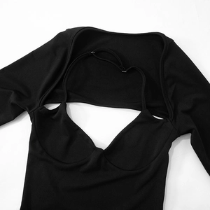 Detail view of black long sleeve top featuring chest cutout and built-in cup pads
