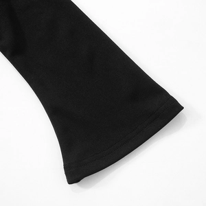Detail of the flared cuff with flatlock stitching on a black elastic knit mini dress