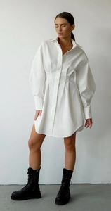 Détail de robe chemise blanche montrant les plis à la taille et les manches bouffantes chic