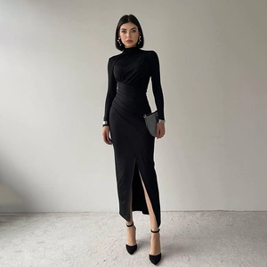 Detail of slim fit high neck dress featuring ruched waist and side slit in black