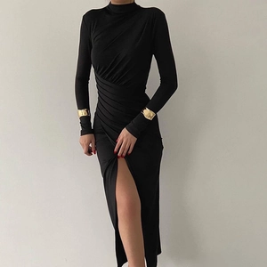 Detail view of mock neck ruched black midi dress with side slit and elegant draping