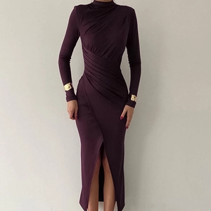 Detailed view of dark purple dress featuring ruched waist and gold metal cuffs