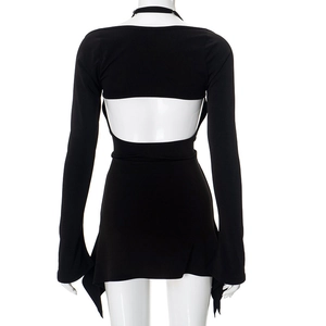 Detail of black backless dress with long sleeves and irregular pointed hemline