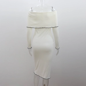 Detail of white rib-knit dress showing black ruffled edges and irregular hemline