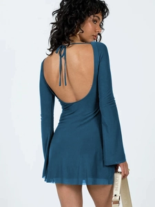 Detail of the backless navy blue mini dress with halter neck tie and bell sleeves