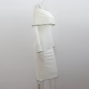 Side view of white off-shoulder knit dress with black ruffled edges on sleeves and hem