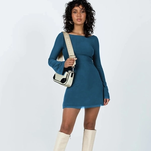 Detail of navy blue slim fit mini dress with off-shoulder design and ruffled long sleeves
