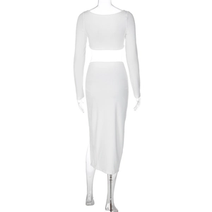 Detail view of the back of a white long-sleeved crop top and high-waisted midi skirt set