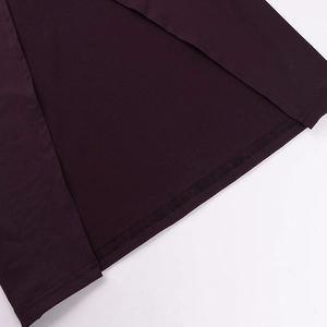Detailed close-up showing the neat hemline and high-quality stitching of the purple dress