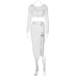 Detail of white long-sleeved V-neck crop top and high-slit maxi skirt with twist knot design