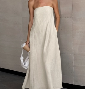 Detail of a khaki strapless linen maxi dress featuring a natural texture and A-line cut
