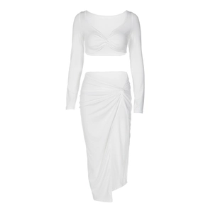 Detail of white two-piece set featuring V-neck cropped top and high-waist ruched skirt