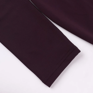Detailed macro view showing the high-quality double-needle stitching on burgundy fabric cuffs