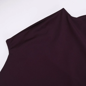 Detail of the high-neck pleated collar on a burgundy knit slim-fit dress for autumn