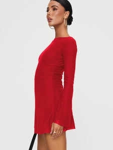 Detail view of the sleek backless design and vibrant red fabric of this sexy mini dress