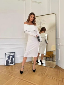 Elegant white off-shoulder long sleeve dress with black trim in a French chic style