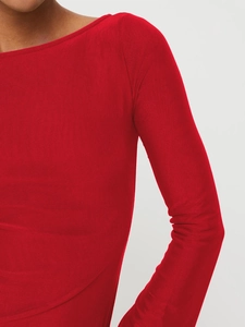 Detail of red off-shoulder mini dress featuring pleated long sleeves and ribbed knit fabric