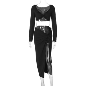 Detail of black two-piece set featuring a v-neck knot crop top and high slit skirt