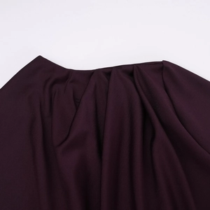 Detail of elegant pleated neckline and gathered fabric on the burgundy autumn dress