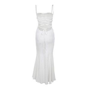 Detail of white backless dress featuring intricate lace-up ties and floral jacquard texture