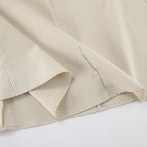Close-up of khaki linen dress hem showing high-quality stitching and natural fabric texture