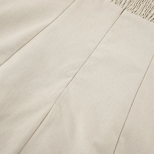 Macro shot of khaki linen fabric with detailed smocking technique and precise stitching