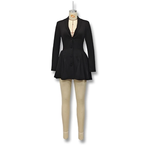 Detail of a black long-sleeve dress with V-neck, buttons, and flared pleated skirt hem
