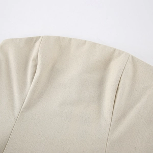 Detailed close-up of khaki linen blend fabric texture and stitching on bandeau dress