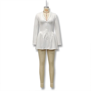 Detail of white deep V-neck dress featuring single-breasted buttons and pleated skirt