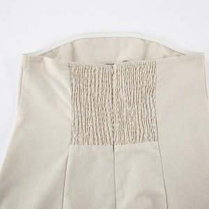Macro shot of khaki cotton linen dress featuring elastic shirring and invisible zipper