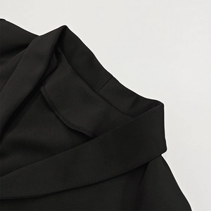 Macro detail of high-density black fabric texture and neat stitching on a V-neck collar