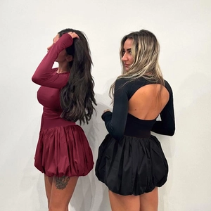 Detail of elegant backless long sleeve bubble dress in burgundy and black colors