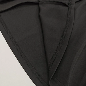 Detailed macro view of the double-needle stitching and high-quality black knit fabric