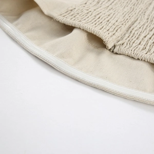 Detail of anti-slip silicone strip, smocking elastic and hidden zipper on khaki linen dress