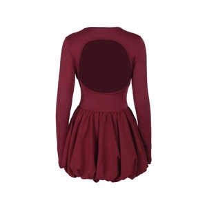 Detail of burgundy long sleeve dress featuring an elegant back cutout and bubble hemline