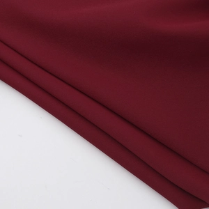 Detailed macro shot of deep red fabric texture and weaving for this slim fit dress