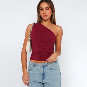 Detail of wine red one-shoulder top showing horizontal ruched design and slim fit cut