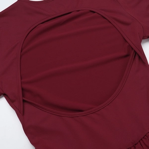 Close-up of elegant wine red dress featuring back cut-out detail and smooth knit texture