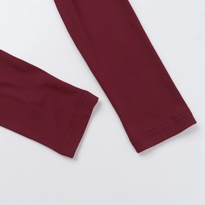 Detailed close-up of double-needle stitching on burgundy long sleeve knit dress cuffs