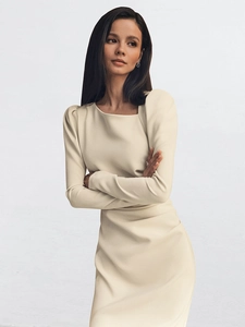 Detail of the elegant square neckline and leg-of-mutton sleeves on a cream dress