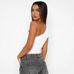 Detail of white one-shoulder slim fit top with side ruching and grey wash jeans