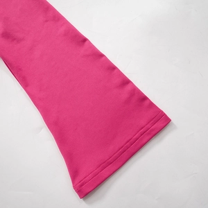 Detail of flared cuff with reinforced double stitching in vibrant hot pink fabric