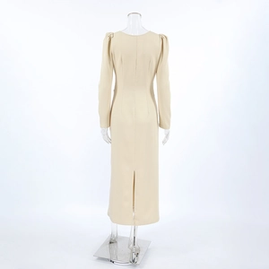 Close-up of beige puff sleeves and back slit detail on elegant maxi dress