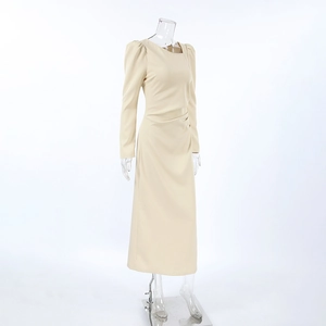 Detail of khakie midi dress featuring asymmetric neckline and ruched waistline accents